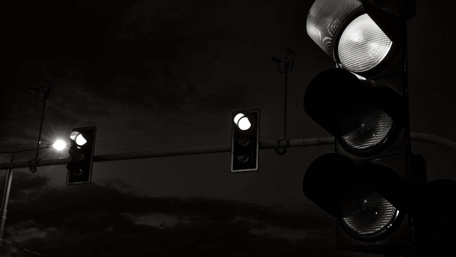 Traffic signals against a dark sky