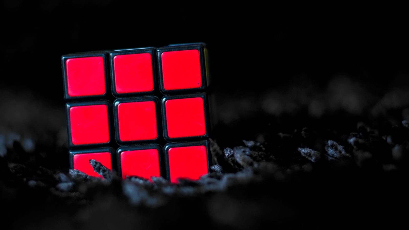 Rubik's Cube resting against a dark gritty background